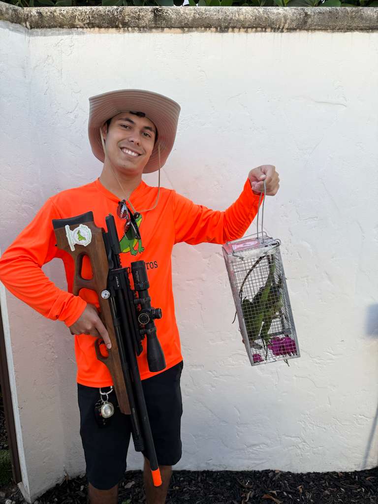 Technician with air rifle and humane trap